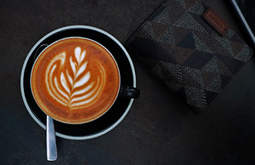 a tray with a cup of coffee and a glass of water